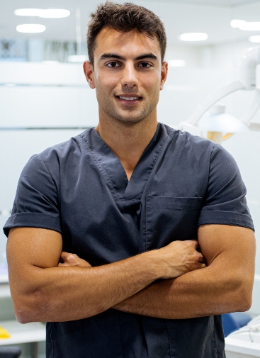 elegant confident man doctor dentist wearing lab coat looking at camera