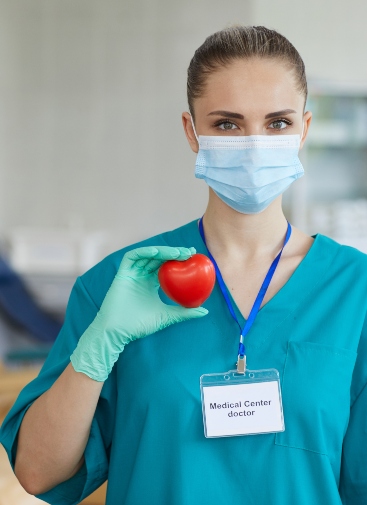 Portrait of young female doctor in mask and in uniform holding heart shape in her hands and looking at camera SSUCv3H4sIAAAAAAAACpxSy47kIAy8r7T/0OI8SIkhD/ZXVnMw4HSjocMoITMatfrf13m1OO8Nl+1yuczj96/LRVicgxN/Lo814jjEuMx5whzSyHD1duATjZ6mEiEfcpoCxhK0mN1txDsxOC4xrvBzS4o5Y15mmtdhB+Qw05U5dvBFsSv6u8eXM7EluYNTQrwV2LzYDTuhnfy/OvfH+7kNXml0P5vgYpGJIuG+yKFRYOepM44k2qqWGnuQvWsHaZ1vqPUDYAfnZNH20PWmBjk4bKU2qpNYNygRfF2RGcAP9Com61SDXkvSmoubRklT950cKrJAjbaVVpv+XbT4+M403UuTcfEhFf5+JYdxLVDFTp9TcGG8Fm0p37Z7n20uLWOeVjNeHoqY0ifauB57YE468RvOM5f7Ey8GOf5d6V7MGVPerDxYhec/sYa1Ag2NgbYD00PVNoeBxz+6BebZ5JxEHLuP4MvVw6pAIGoAYIOtRcXHIZDIxkmFxqm6H/paG7bw+Q8AAP//AwAw/zm9EQMAAA==